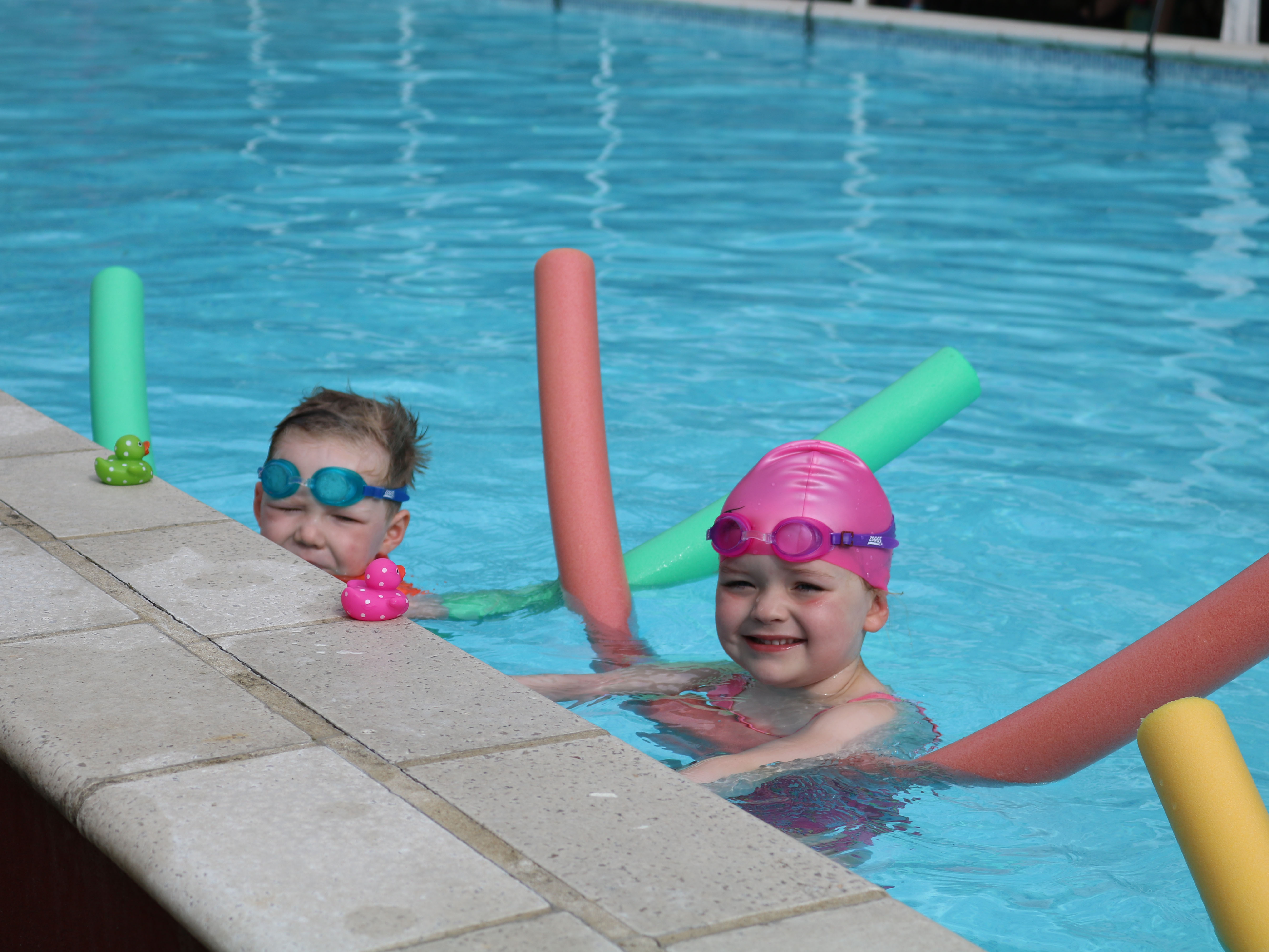 Children enjoying swimming lessons together